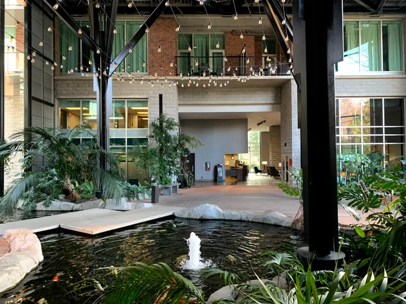 The Parkside atrium and koi pond by day