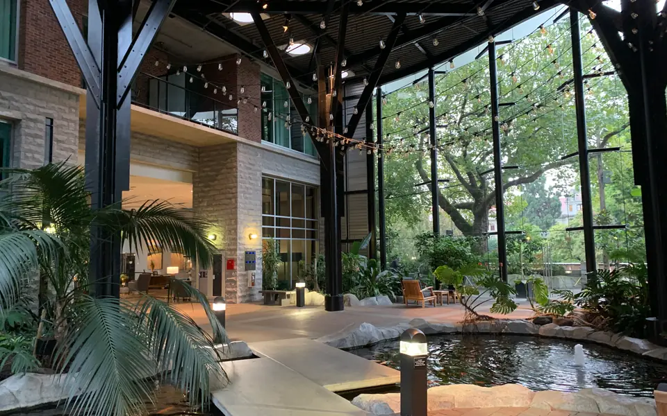 The glass-roofed atrium and koi pond at the Parkside Hotel & Spa at dusk