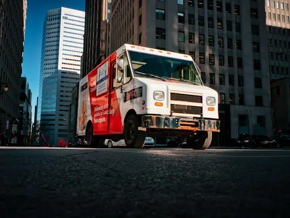 A Canada Post delivery truck on a downtown street