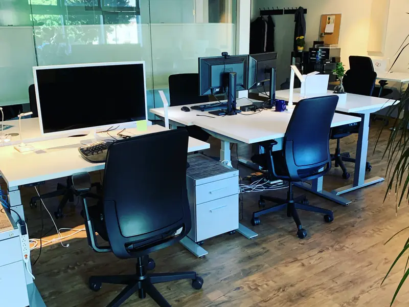 Dedicated electric sit/stand desks with ergonomic chairs and monitors